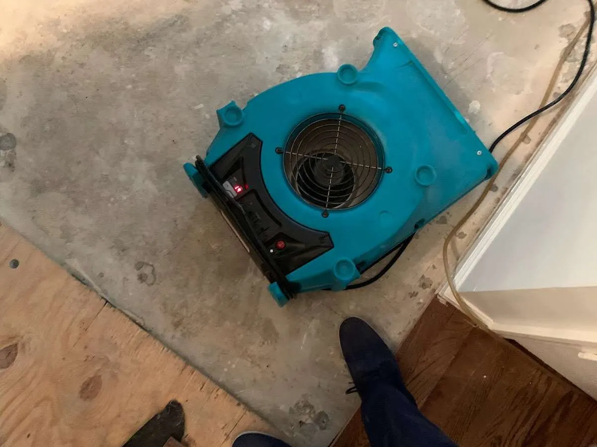 Air mover drying subfloor during Commercial Water Damage Restoration in Wolcott